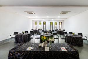 a banquet hall with tables and chairs in a room at Anandam - A Luxury Resort in Udaipur in Udaipur +163 photos