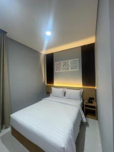 a bedroom with a large bed with white sheets at Agiva Hotel in Kurinci