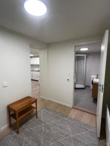 an empty room with a table and a mirror at Nyoppusset leilighet i Vadsø in Vadsø