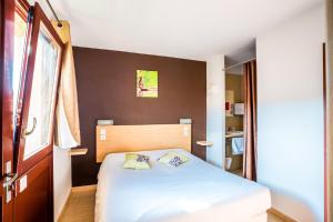 Postel nebo postele na pokoji v ubytování Hôtel Acajou
