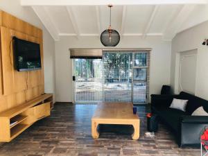 a living room with a couch and a coffee table at Twin Power Guesthouse in Bloemfontein