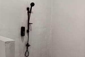a microphone on a wall in a room at La Plage Beach Club in Tjikakaka