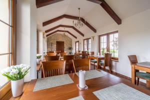 a dining room with wooden tables and chairs at Penzion Mušlov in Mikulov
