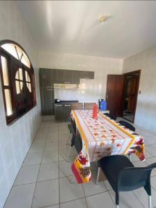 a kitchen with a table and chairs in a room at Praia do fort in Camacari