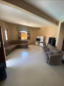 a large living room with couches and a couch at Praia do fort in Camacari