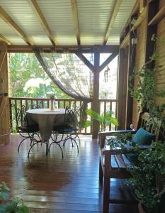 a large room with a bath tub on a porch at Le Jardin des Passiflores in Sainte-Rose
