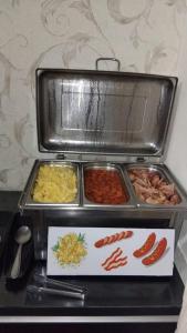 a tray of food on top of a counter at Hotel Confort Maringá in Maringá