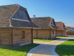 a house with a pitched roof and a driveway at Edvy Malom Apartmanok Pápa in Pápa