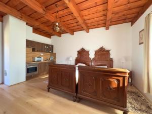 a kitchen with a large wooden island in a room at Edvy Malom Apartmanok Pápa in Pápa