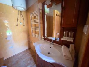 a bathroom with a sink and a mirror and a shower at Edvy Malom Apartmanok Pápa in Pápa +42 photos