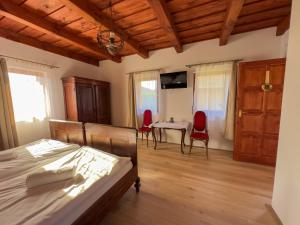 a bedroom with a bed and a table and chairs at Edvy Malom Apartmanok Pápa in Pápa
