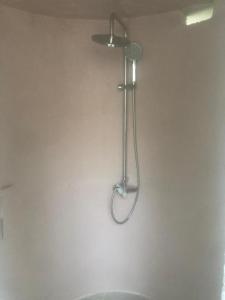 a shower in a bathroom with a shower head at Barreira beachfront Tents 9 in Verga Kalamata