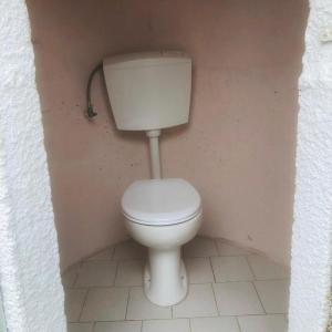 a bathroom with a white toilet in a room at Barreira beachfront Tents 9 in Verga Kalamata +5 photos