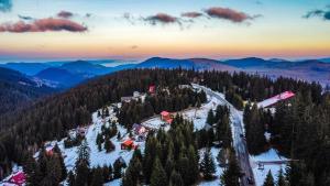 an aerial view of a ski resort in the mountains at Pensiunea Patru Brazi in Muntele Cacovei