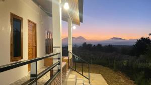 a house with a balcony with a view of the mountains at TN House in Pai