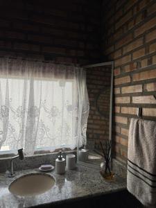 a bathroom with a sink and a window at Incanto in Niterói