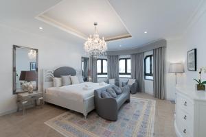 a large bedroom with a bed and a chandelier at Palm Jumeirah - Property Advisers in Dubai +12 photos