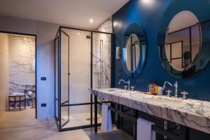a bathroom with two sinks and a shower at Boutique Hotel Trieste - Adults Only in Verona +61 photos