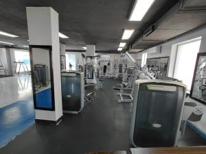 a gym with a row of urinals and machines at Badan Suites & Hotel in Amman