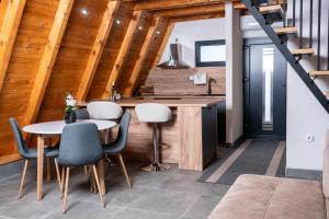 a kitchen and dining room with a table and chairs at Kozara Resort in Gornji Podgradci