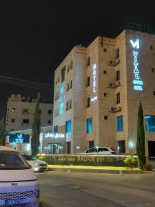 a building with a sign on the side of it at Badan Suites & Hotel in Amman