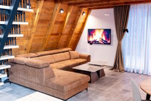 a living room with a couch and a table at Kozara Resort in Gornji Podgradci