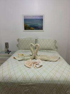 a bedroom with a bed with a towel on it at Imbassai Summer Flats Village in Imbassai +65 photos