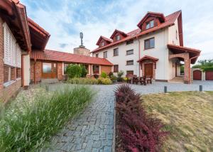 an exterior view of a house with a brick driveway at Penzion Mušlov in Mikulov