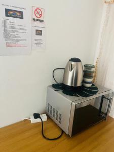 a tea kettle sitting on top of a microwave at Rainbow Palace in Bloemfontein