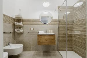 a bathroom with a sink and a shower at Holiday burrone in Favignana +18 photos
