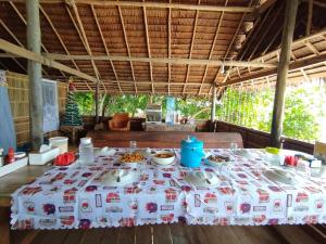 a table with plates of food on top of it at Batanta Panorama Homestay in Dayang