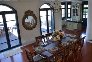a dining room with a table with chairs and a mirror at Mikamas Villas in Pyrgi Thermis
