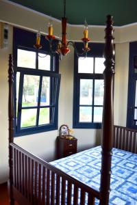 a bedroom with a bed and two windows at Mikamas Villas in Pyrgi Thermis +43 photos