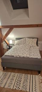 a bed sitting in a room with a bed sidx sidx at Fewo Jura Hills in Pommelsbrunn