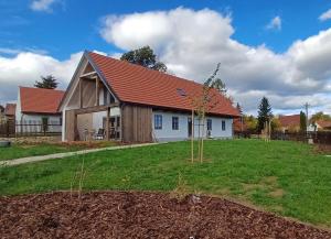 a house with a tree in the yard at Chalupa Louka in Slavonice