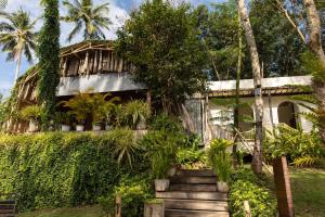 a house with stairs leading up to it at Hideout Koh Kood in Ko Kood