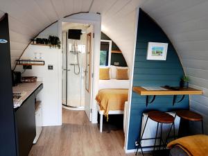 a small room with a bed and a bathroom at The Nest in Doolin