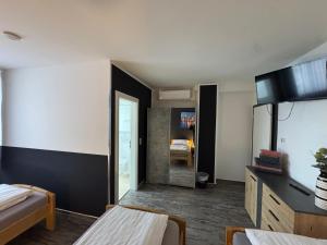 a hotel room with two beds and a mirror at Pension Zwei A in Leverkusen