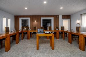 a large room with long wooden tables and chairs at Monte do Giestal - Casas de Campo & Spa in Abela +129 photos