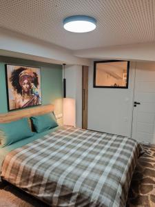 a bedroom with a large bed with a checkered blanket at Φεγγαρόπετρα-Ημισέληνος in Kalívia