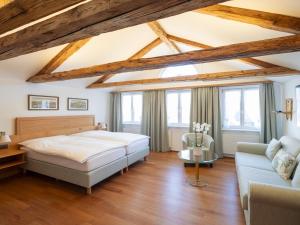 a bedroom with a bed and a couch at Hotel Löwen in Appenzell