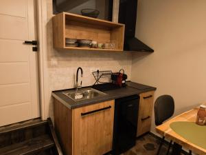 a kitchen with a sink and a counter top at Φεγγαρόπετρα-Ημισέληνος in Kalívia