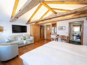 a bedroom with a bed and a living room at Hotel Löwen in Appenzell