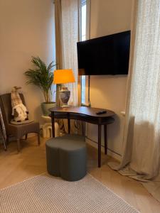 a living room with a table with a lamp and a chair at Huyze Elise Free Parking in Ostend +12 photos