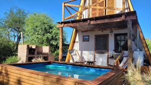 a house with a swimming pool in the backyard at Cabañas Sacha Huasi in Travesía +18 photos