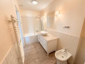 a white bathroom with a sink and a toilet at Złote Runo - Kameralny hotelik & Restauracja in Karolina