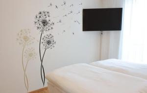 a bedroom with a wall mural of flowers and butterflies at Apartments Kellergasse in Purbach am Neusiedlersee