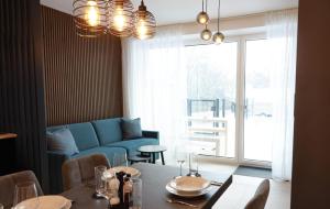 a living room with a table and a blue couch at Apartments Kellergasse in Purbach am Neusiedlersee