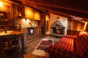a living room with a couch and a fireplace at Au Coeur Des Neiges Resort SPA & FREE E-BIKE in Courmayeur