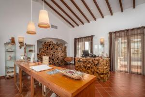 a room with a table and a pile of logs at Monte do Giestal - Casas de Campo & Spa in Abela